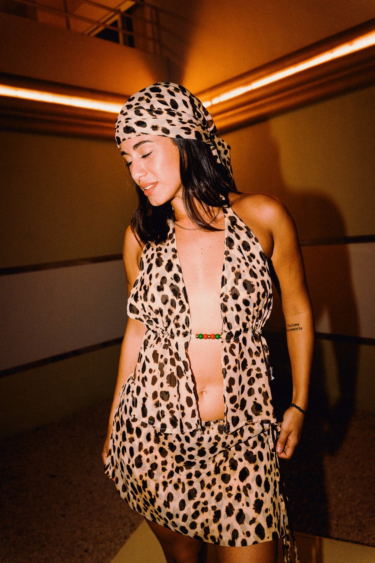 CHICHI cheetah print headscarf worn tied over the hair with matching two-piece outfit