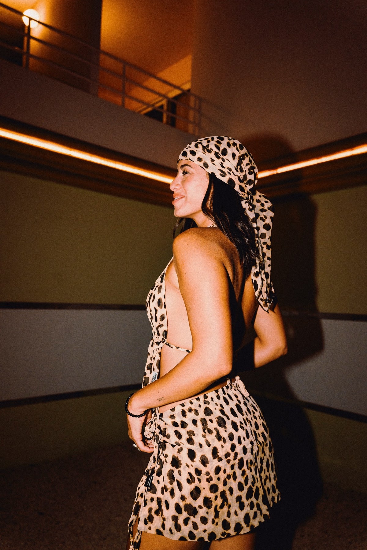 Side view of CHICHI cheetah print mini skirt with tasseled side tie