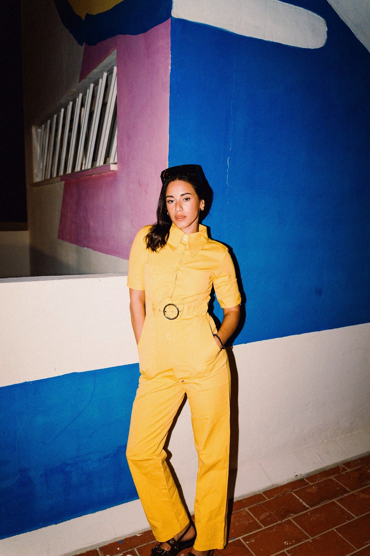 HEIDI Buttercup Yellow belted stretch cotton jumpsuit – OOTO Clothing editorial image 2