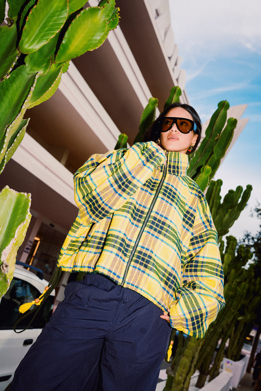STOOP yellow fleece jacket styled outdoors with wide leg trousers