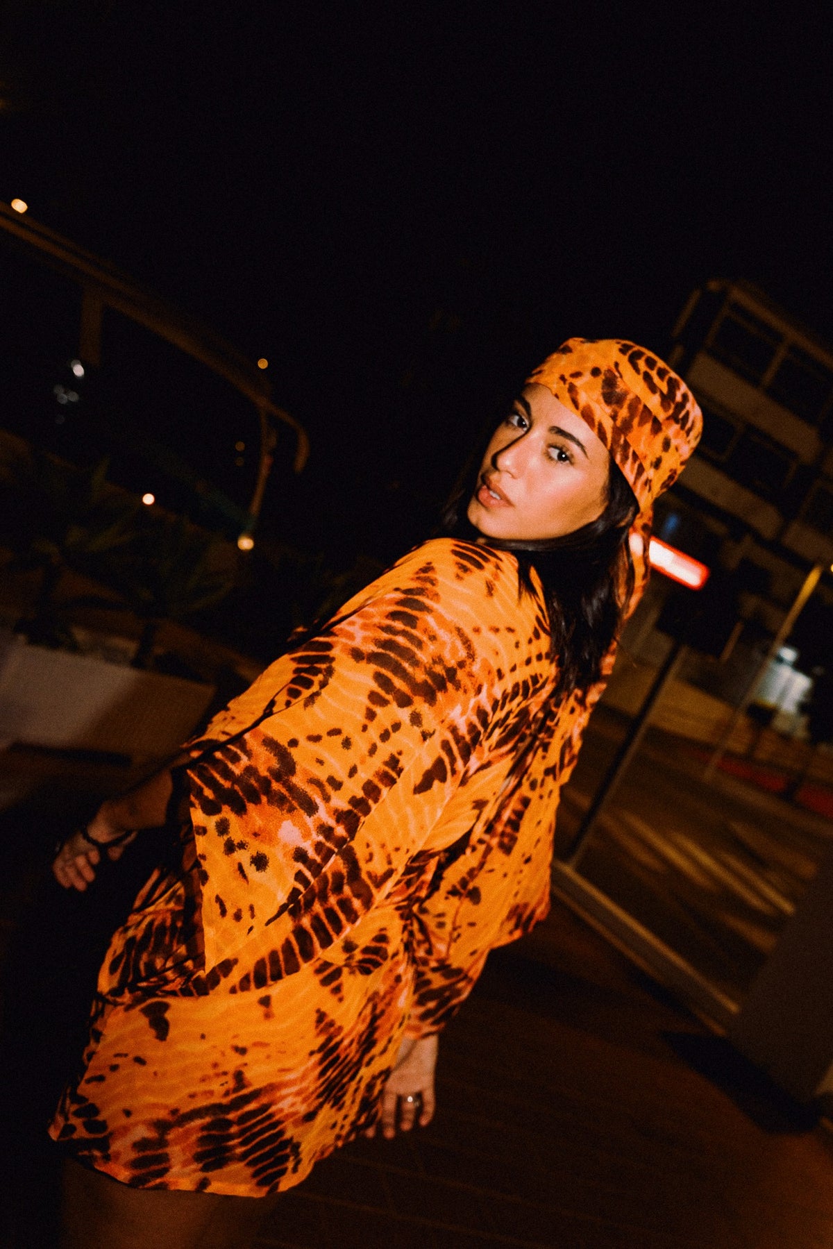 SOLARA orange and brown tie-dye batwing mini dress by OOTO Clothing, editorial photo 00540