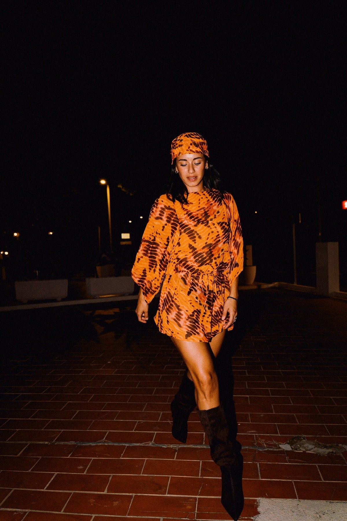 SOLARA orange tie-dye headscarf styled with matching mini dress – editorial photograph 00566