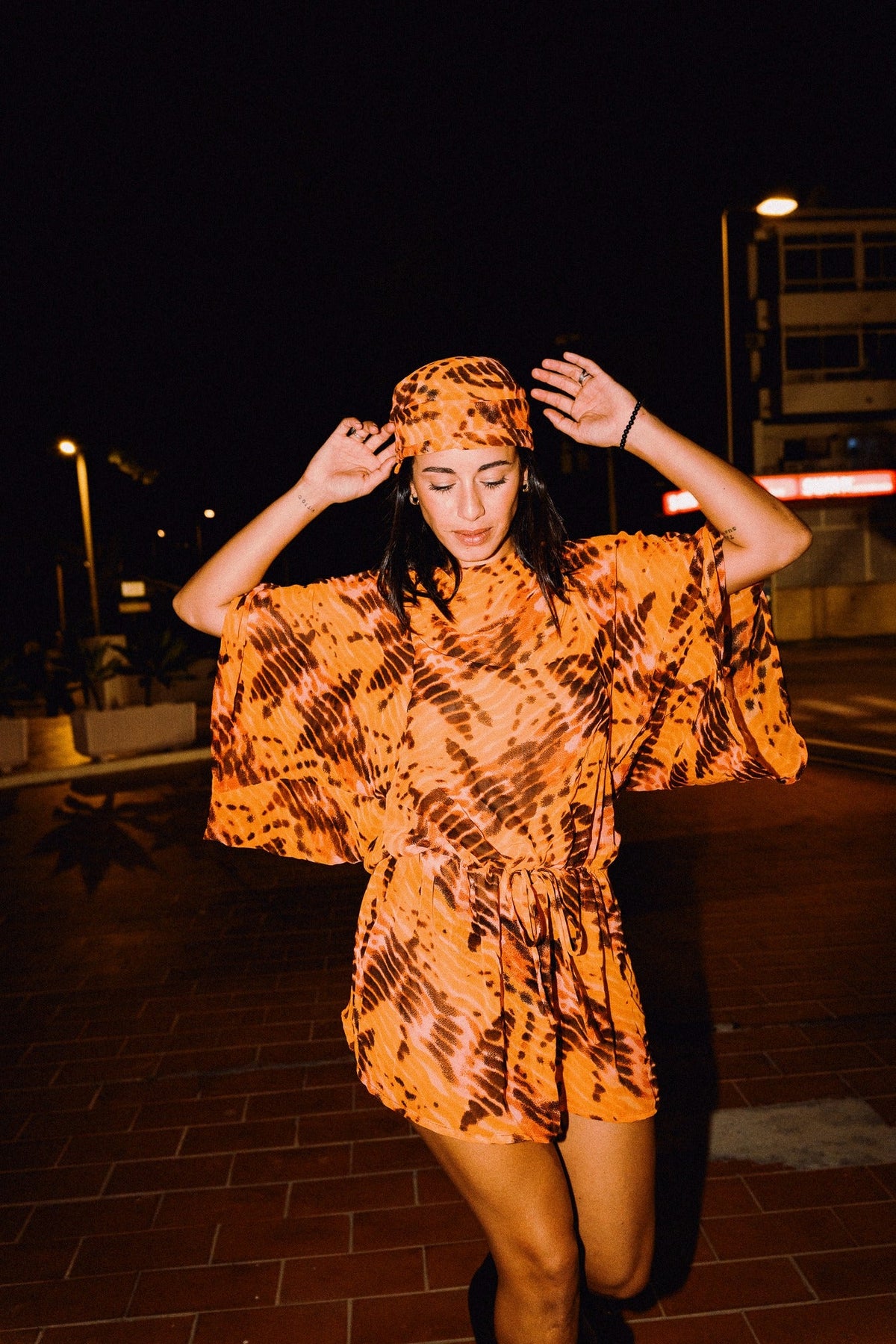 SOLARA orange tie-dye headscarf styled with matching chiffon dress