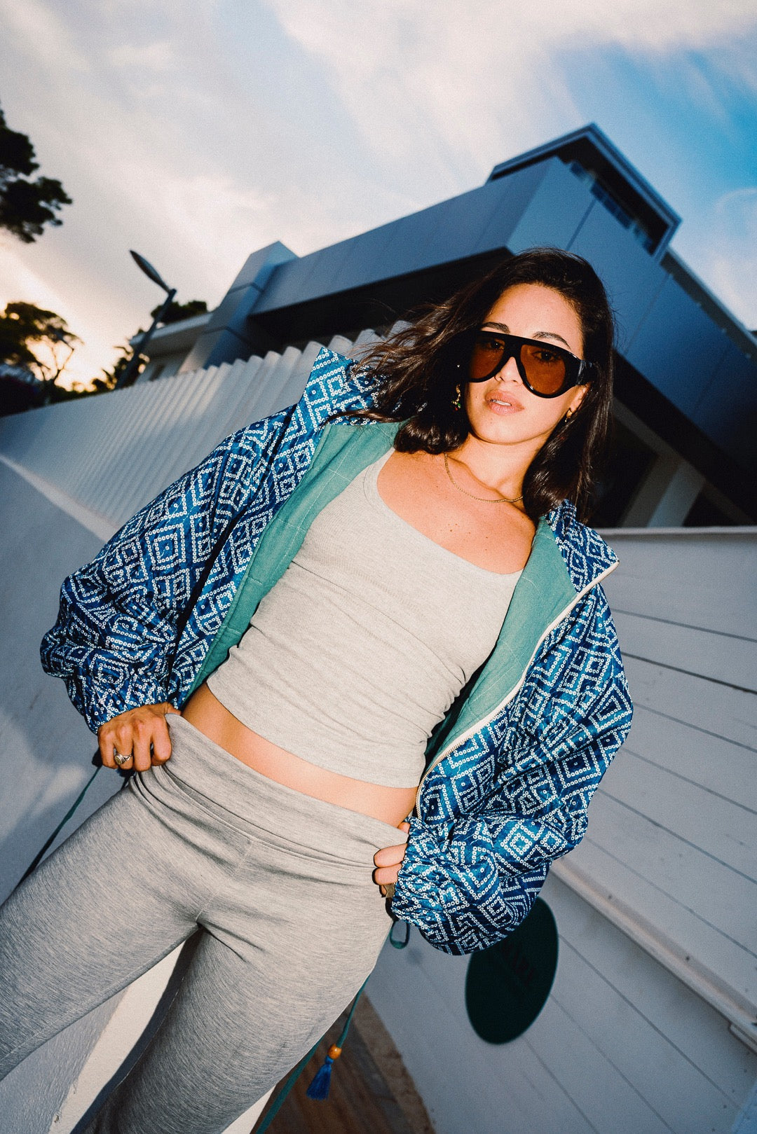 STOOP denim blue geometric bomber jacket with turquoise lining and adjustable tassel ties, model view 2
