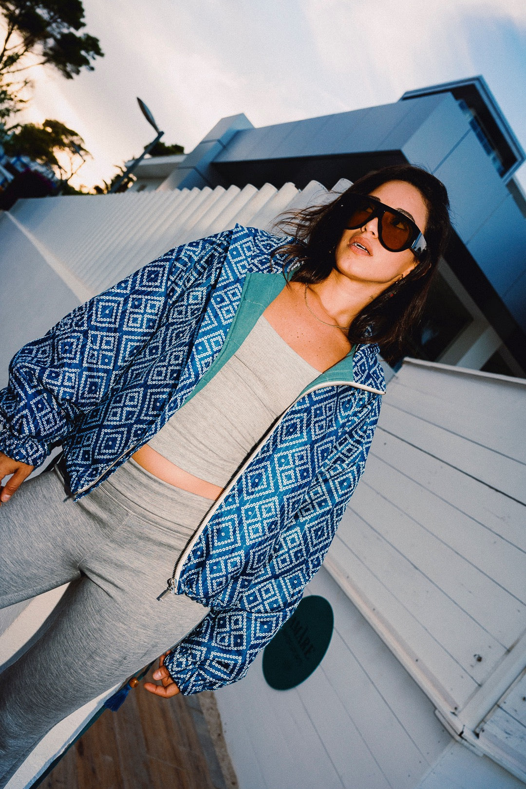 STOOP denim blue geometric bomber jacket with turquoise lining and adjustable tassel ties, model view 3