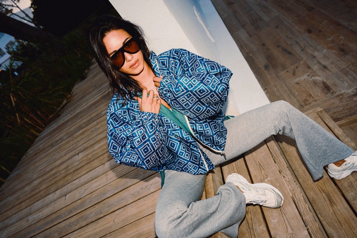 STOOP denim blue geometric bomber jacket with turquoise lining and adjustable tassel ties, model view 9
