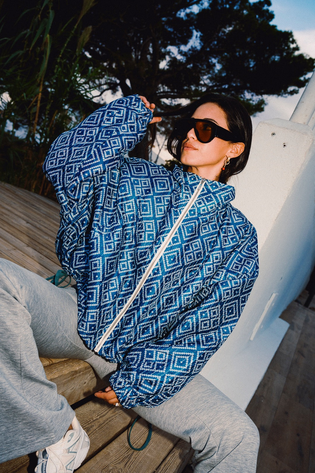STOOP denim blue geometric bomber jacket with turquoise lining and adjustable tassel ties, model view 10