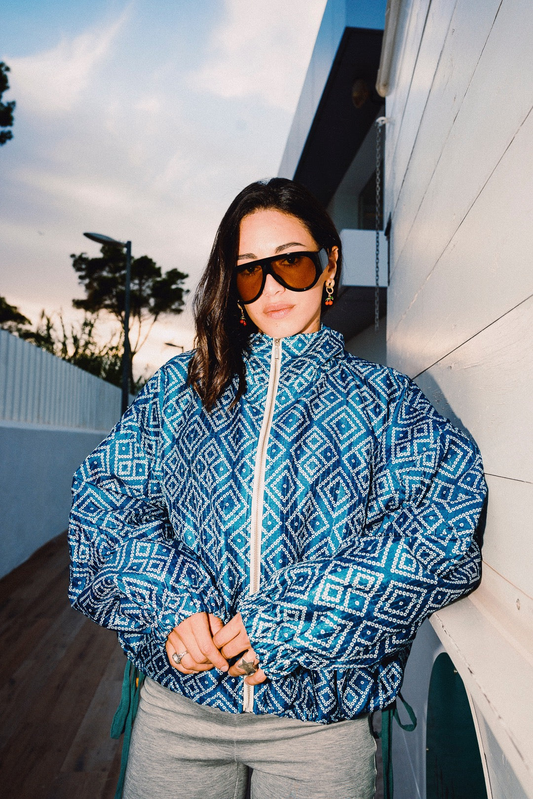 STOOP denim blue geometric bomber jacket with turquoise lining and adjustable tassel ties, model view 11