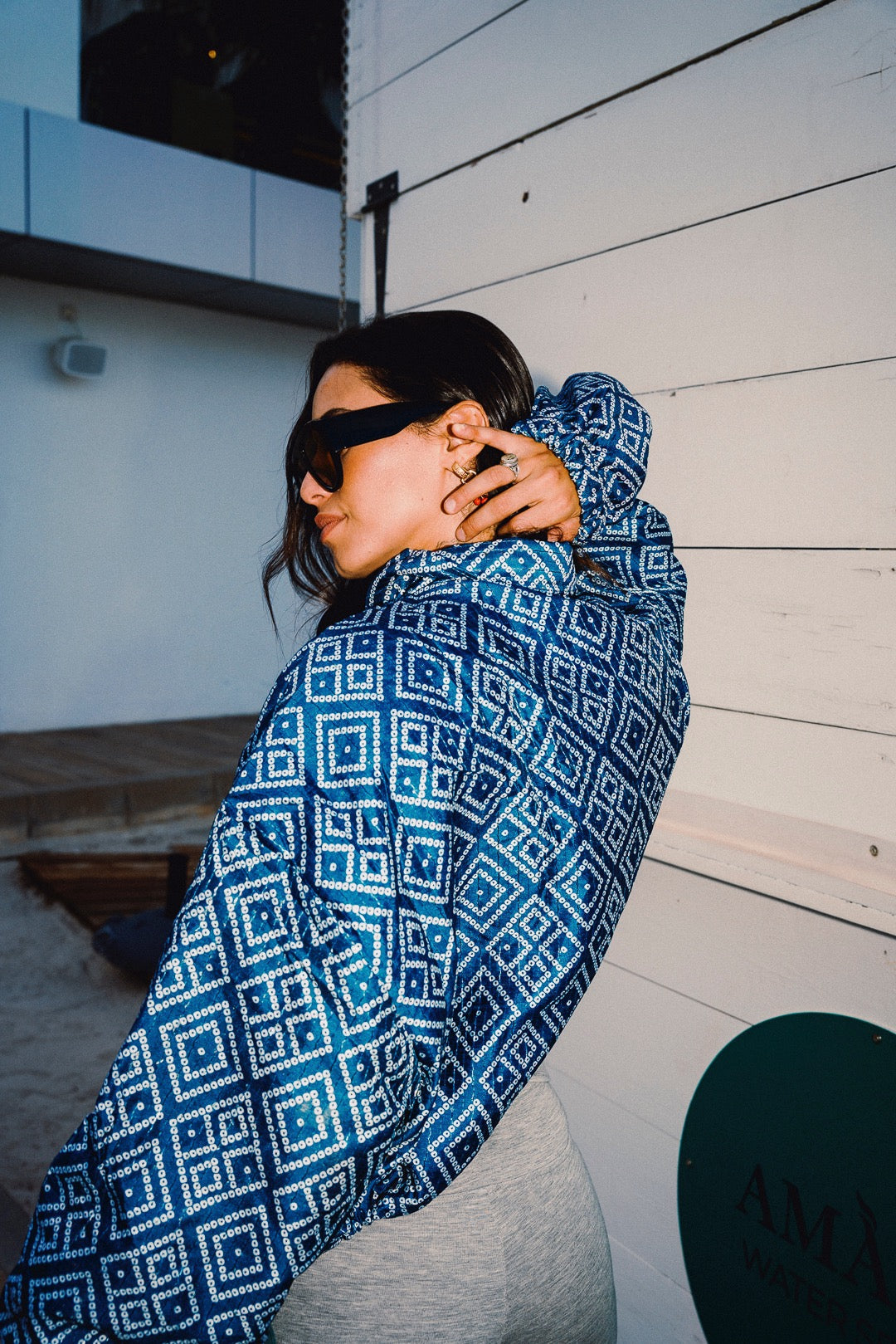STOOP denim blue geometric bomber jacket with turquoise lining and adjustable tassel ties, model view 13
