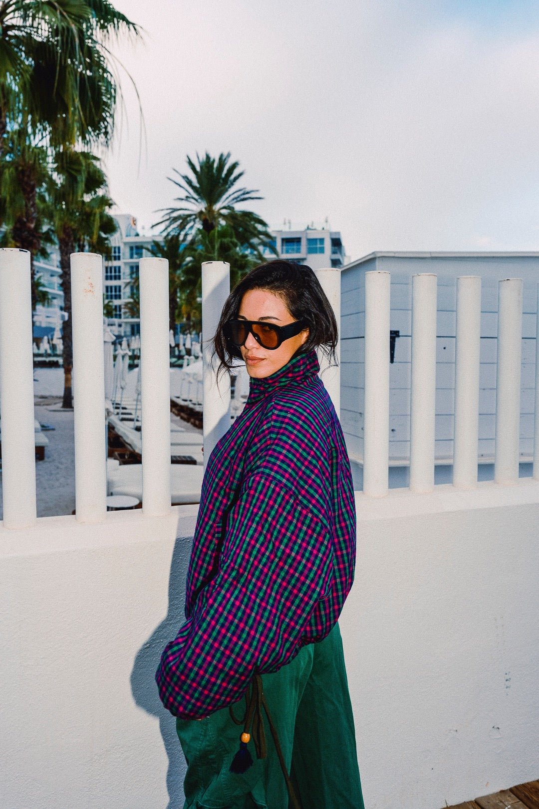 STOOP pink and navy checked oversized bomber jacket, styled with green trousers, view 1