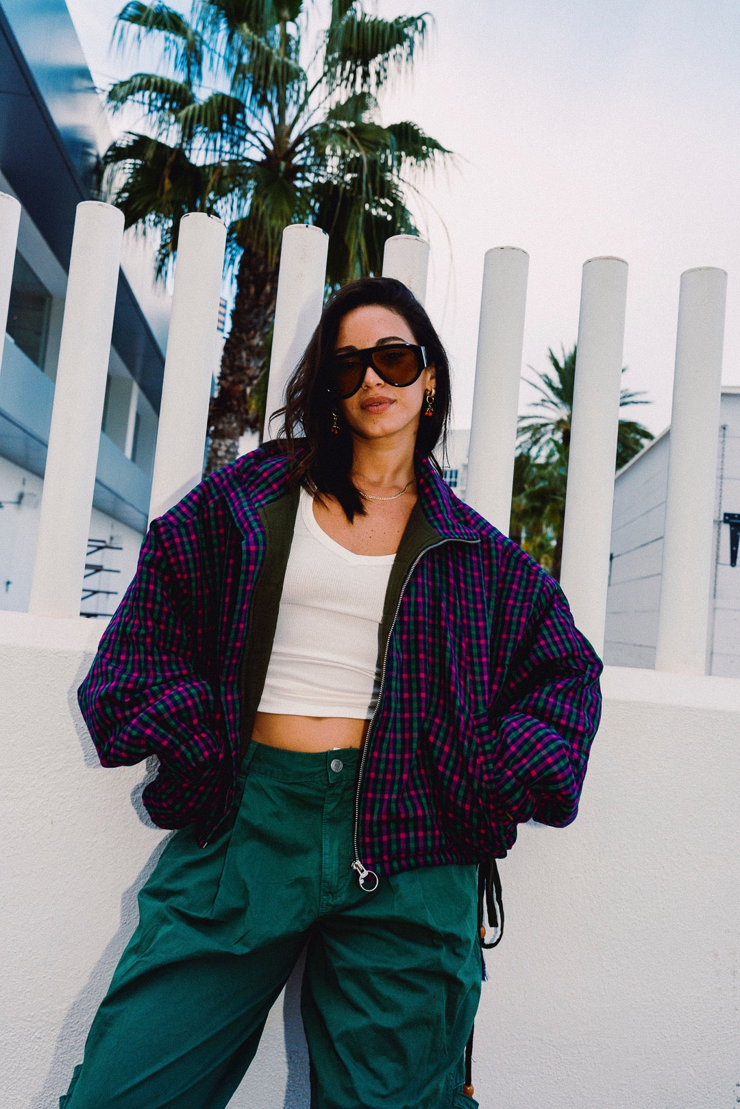STOOP pink and navy checked oversized bomber jacket, styled with green trousers, view 7