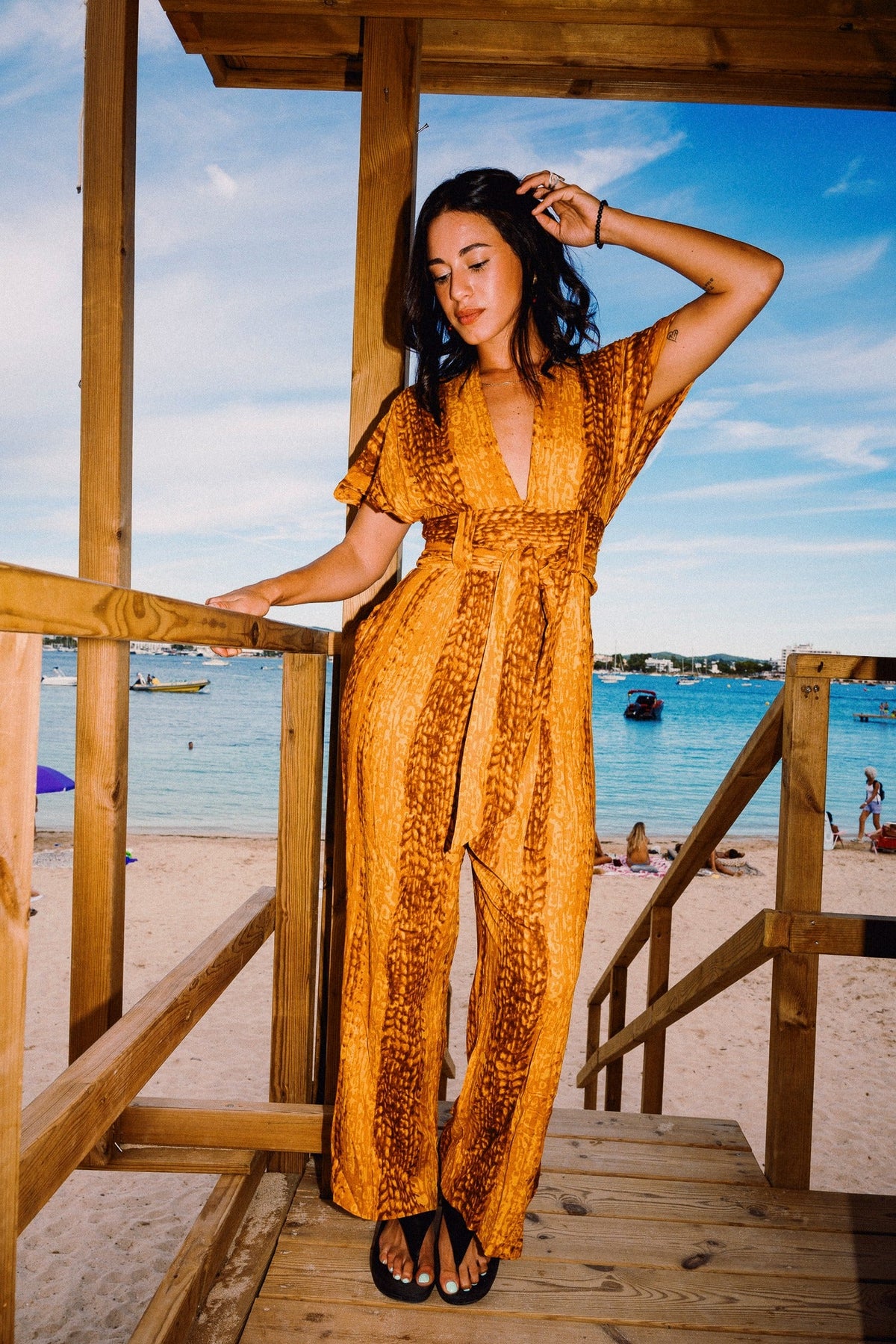 TINA REFINED Golden Hour jumpsuit – Full-length beach steps pose